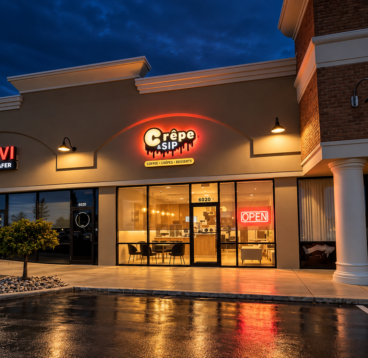 The Crêpe & Sip storefront glowing at night with its chocolate-drop sign